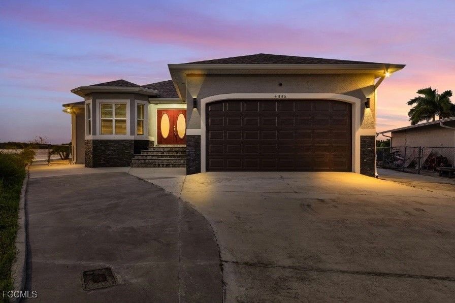 4885 East Riverside Drive Fort Myers, FL 33905 - Photo 2 of 45 a front view of a house with a yard