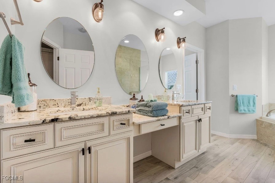 4885 East Riverside Drive Fort Myers, FL 33905 - Photo 22 of 45 a bathroom with a double vanity sink and a mirror