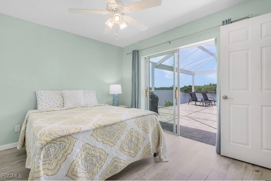 4885 East Riverside Drive Fort Myers, FL 33905 - Photo 23 of 45 a bedroom with a large bed and a chandelier fan
