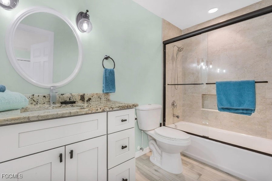 4885 East Riverside Drive Fort Myers, FL 33905 - Photo 27 of 45 a bathroom with a granite countertop sink mirror vanity and toilet
