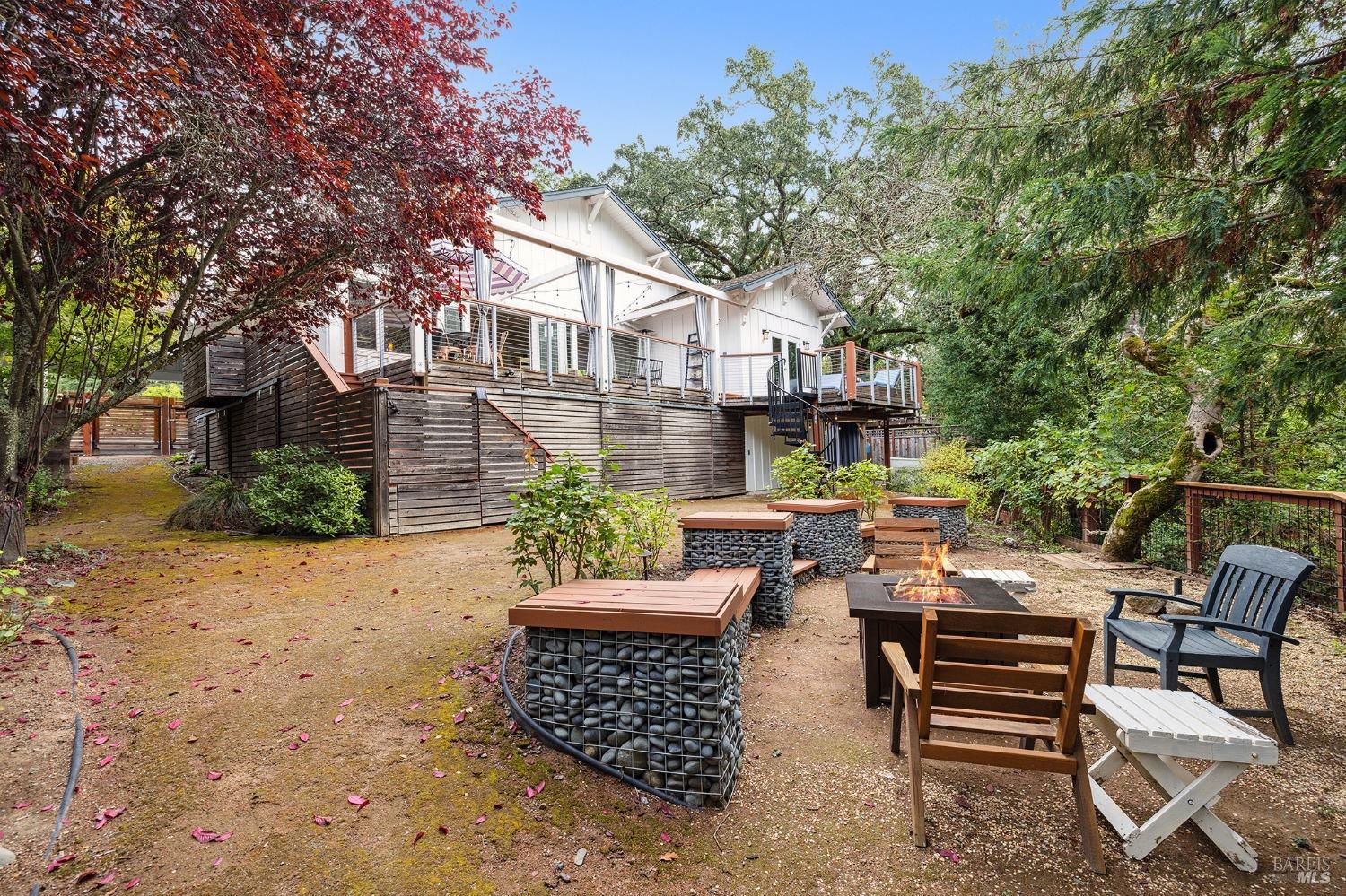 a view of a patio with table and chairs and potted plants