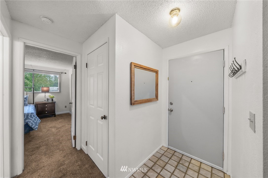 17536 149th Avenue Southeast, Unit O12 Renton, WA 98058 - Photo 2 of 12 a view of a bedroom from a hallway