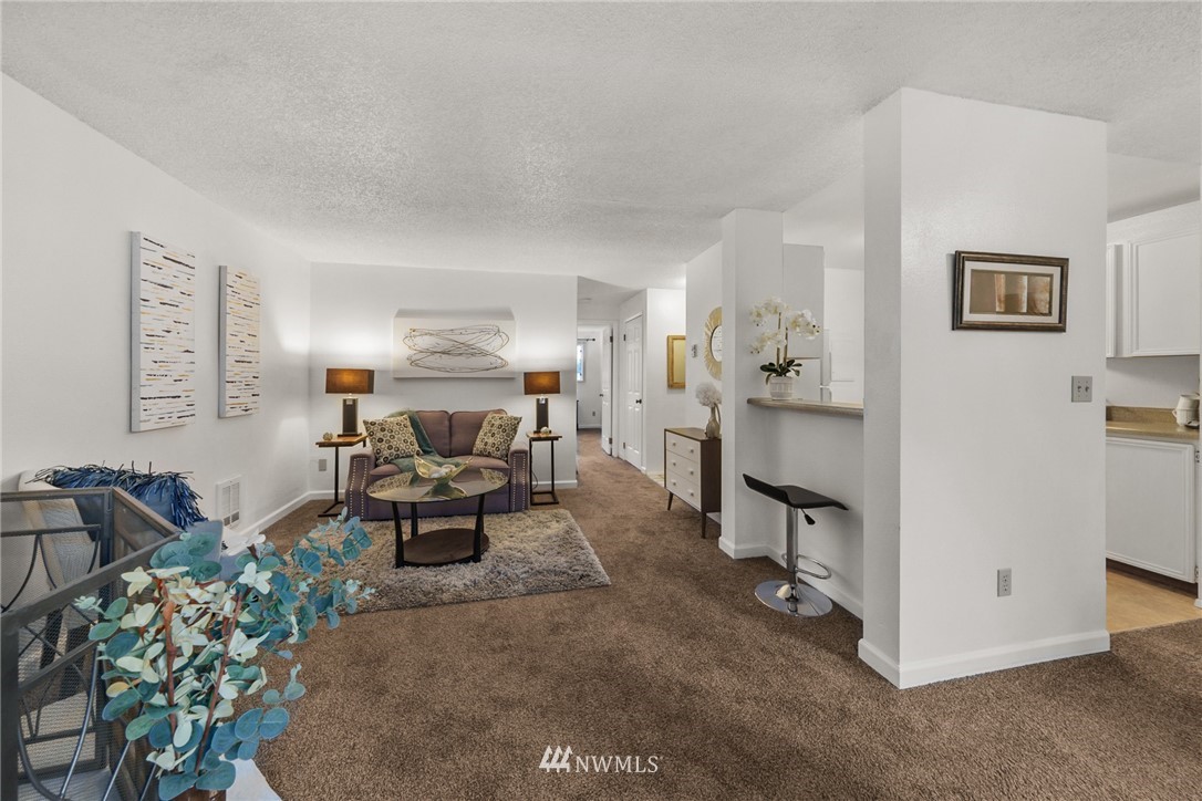 17536 149th Avenue Southeast, Unit O12 Renton, WA 98058 - Photo 4 of 12 a living room with furniture and a chandelier