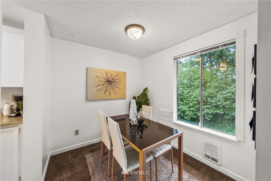 17536 149th Avenue Southeast, Unit O12 Renton, WA 98058 - Photo 5 of 12 a view of a workspace with furniture and a window