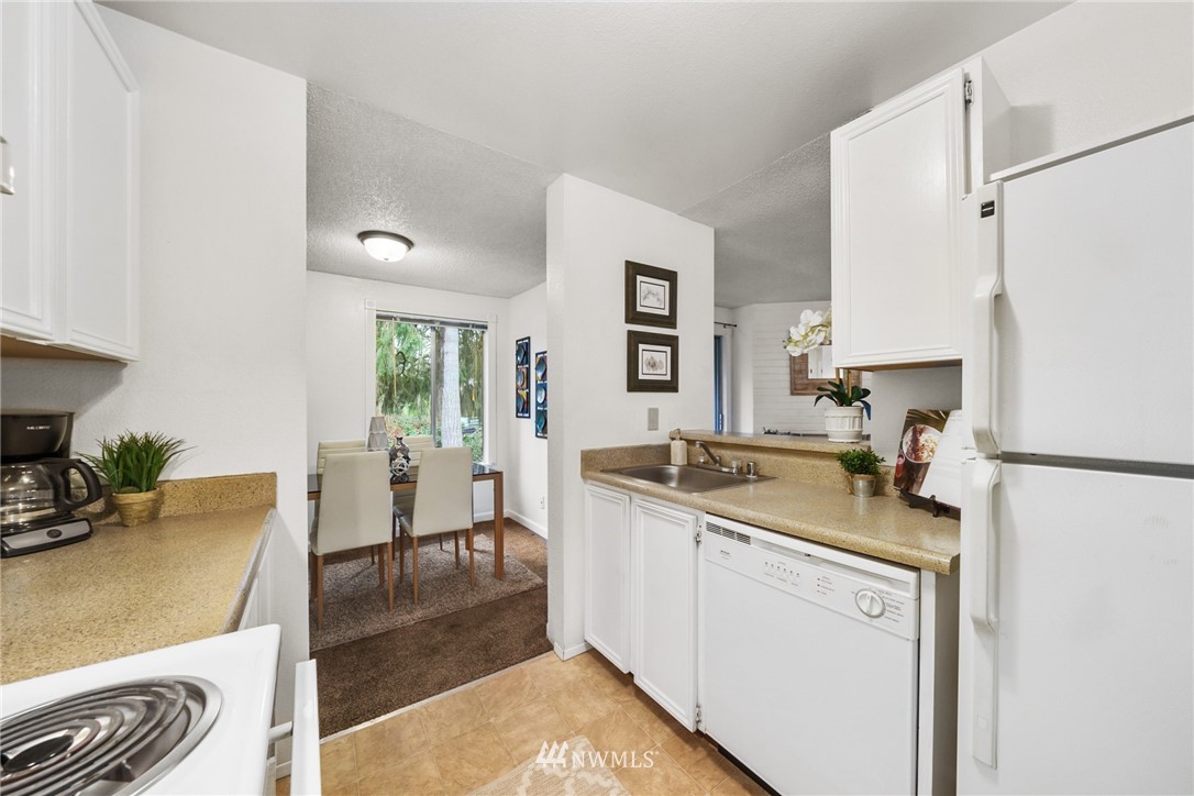 17536 149th Avenue Southeast, Unit O12 Renton, WA 98058 - Photo 7 of 12 a kitchen with a sink stove and refrigerator