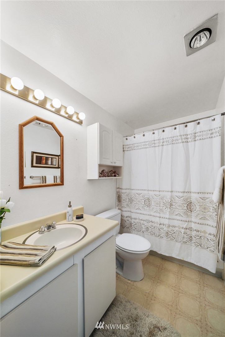 17536 149th Avenue Southeast, Unit O12 Renton, WA 98058 - Photo 10 of 12 a bathroom with a double vanity sink mirror and toilet