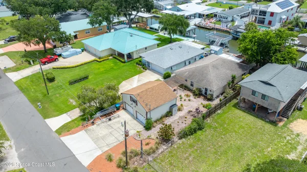 an aerial view of a house with a garden and swimming pool