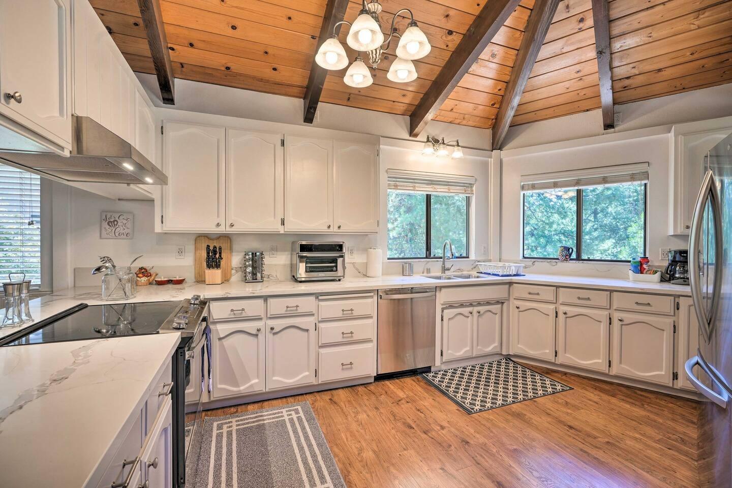1870 Cable Road Camino, CA 95709 - Photo 7 of 36 a large white kitchen with a large window a sink and cabinets