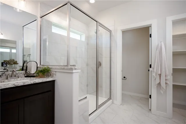 a bathroom with a double vanity sink and mirror