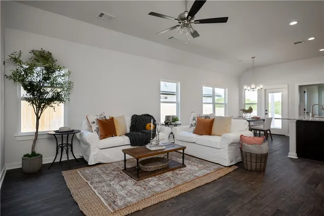 a living room with furniture or couch and a potted plant