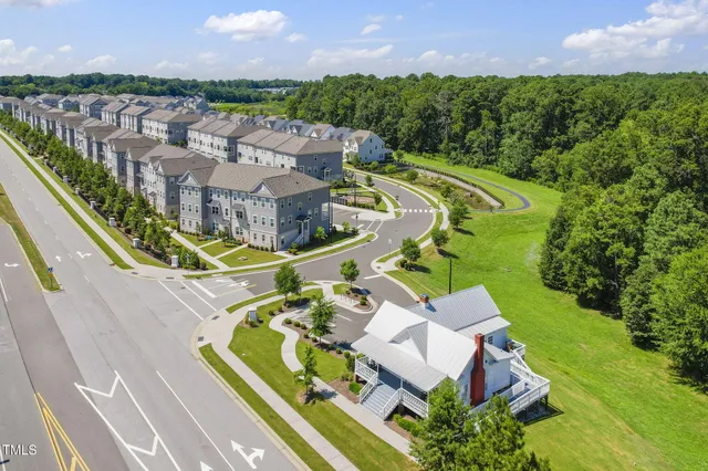 a front view of a residential apartment building with a yard