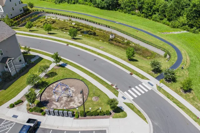 an aerial view of a house with a garden and swimming pool
