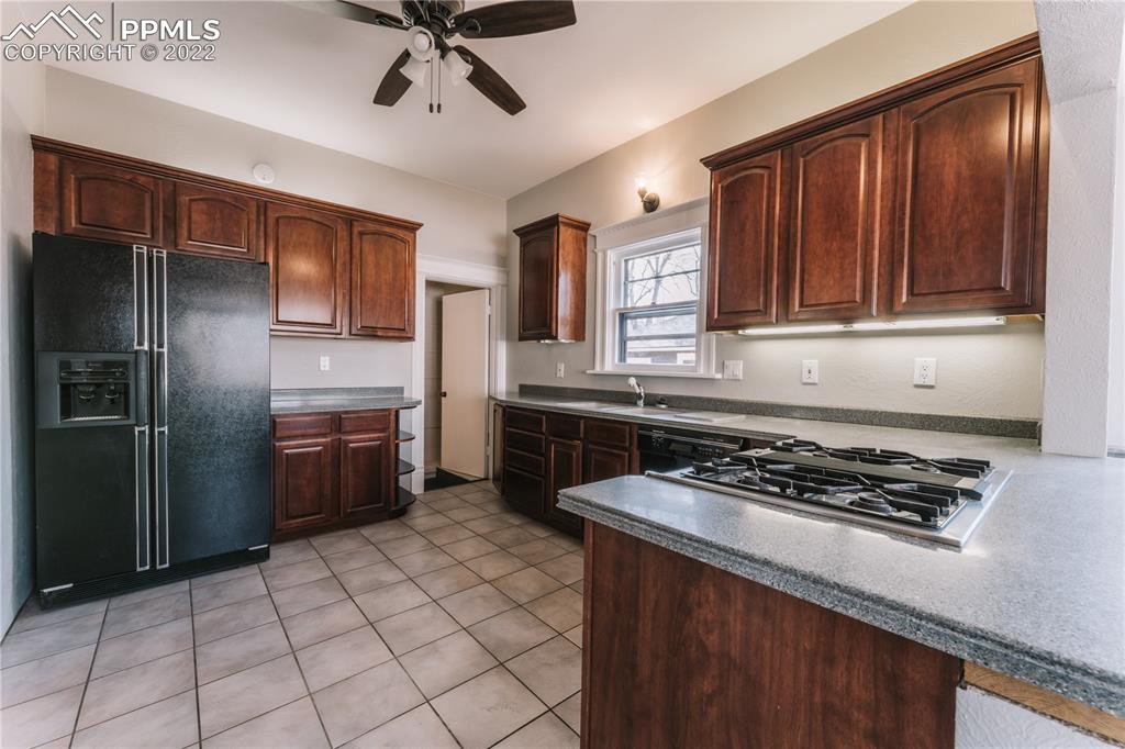 1018 East Boulder Street Colorado Springs, CO 80903 - Photo 11 of 40 a kitchen with granite countertop a stove sink and refrigerator