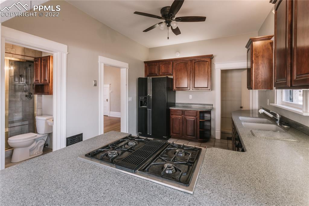 1018 East Boulder Street Colorado Springs, CO 80903 - Photo 12 of 40 a kitchen with stainless steel appliances granite countertop a refrigerator stove and sink