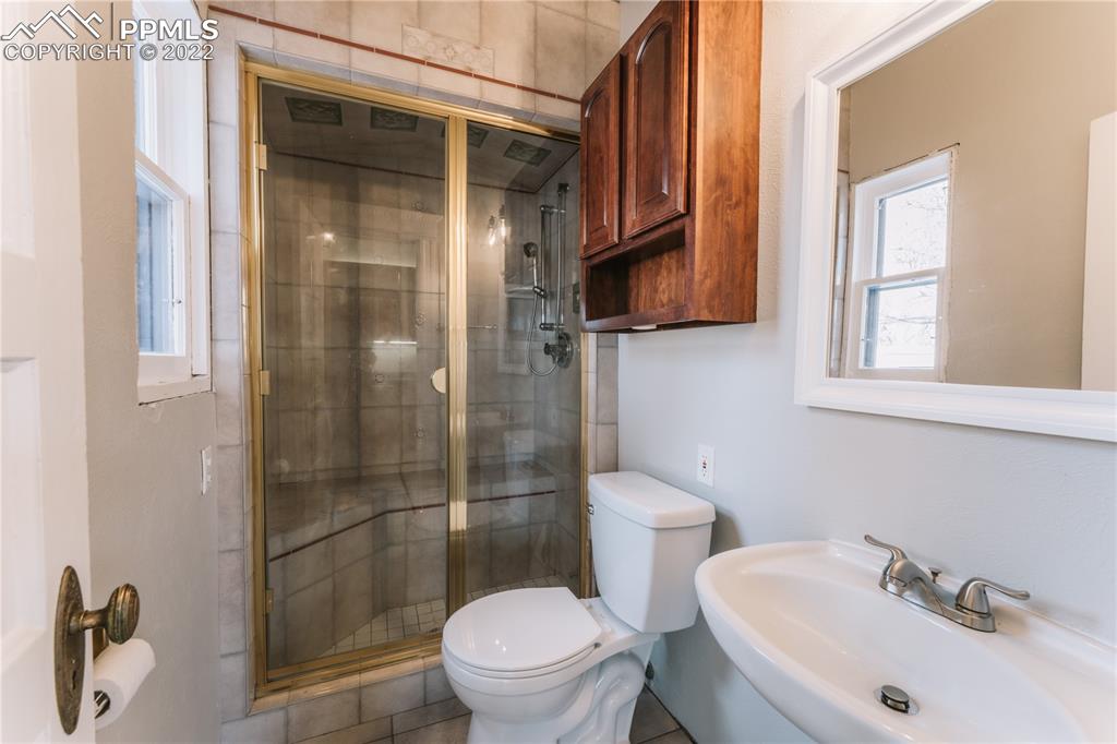 1018 East Boulder Street Colorado Springs, CO 80903 - Photo 15 of 40 a white toilet sitting next to a bathroom sink