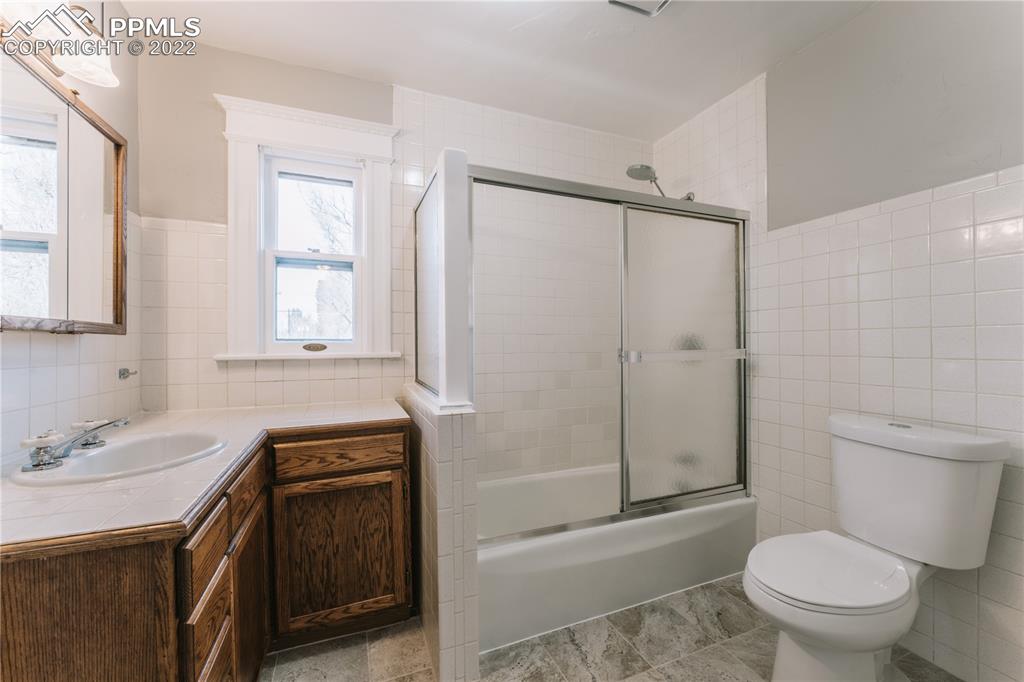 1018 East Boulder Street Colorado Springs, CO 80903 - Photo 23 of 40 a bathroom with a sink a toilet and shower