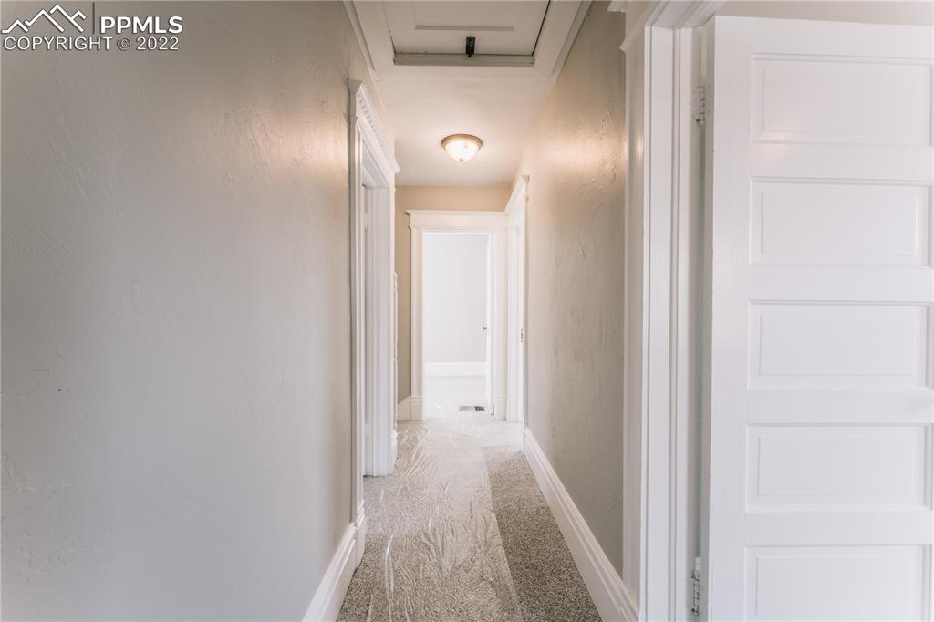 1018 East Boulder Street Colorado Springs, CO 80903 - Photo 24 of 40 a view of a hallway with wooden floor