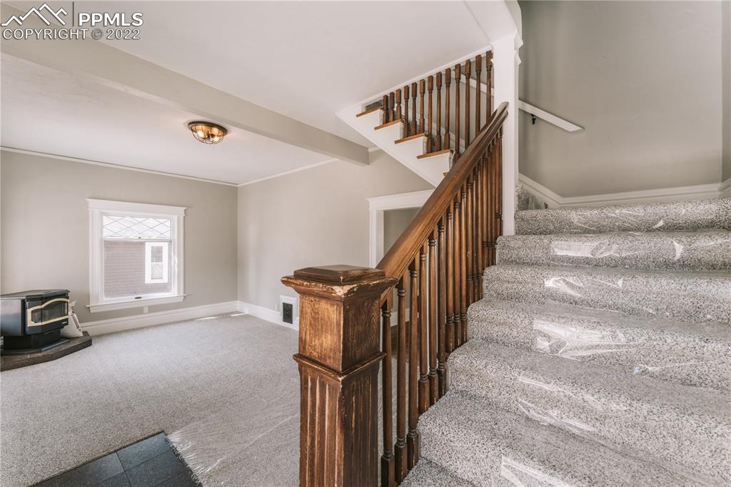 1018 East Boulder Street Colorado Springs, CO 80903 - Photo 7 of 40 a view of staircase with white walls and a window