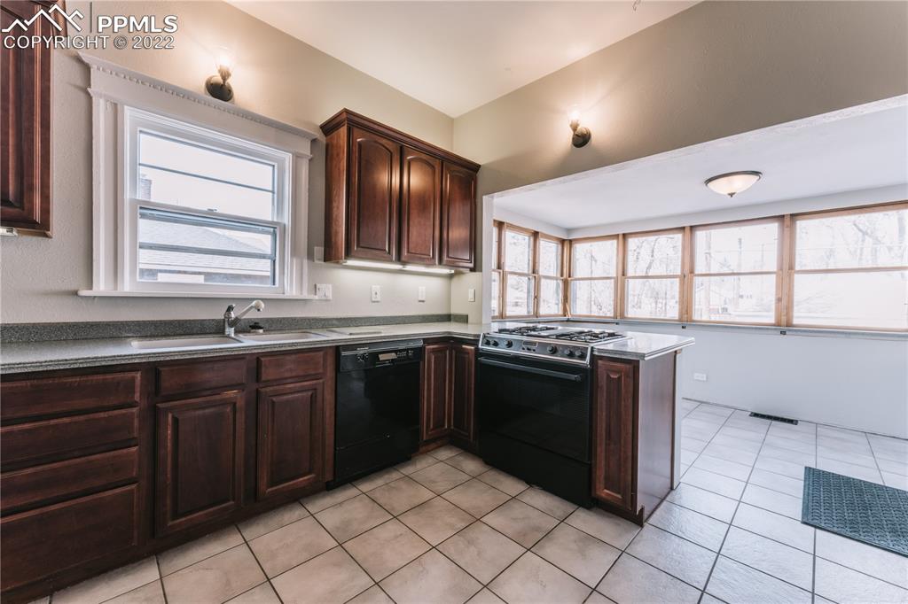 1018 East Boulder Street Colorado Springs, CO 80903 - Photo 10 of 40 a kitchen with stainless steel appliances granite countertop a stove a sink and a microwave