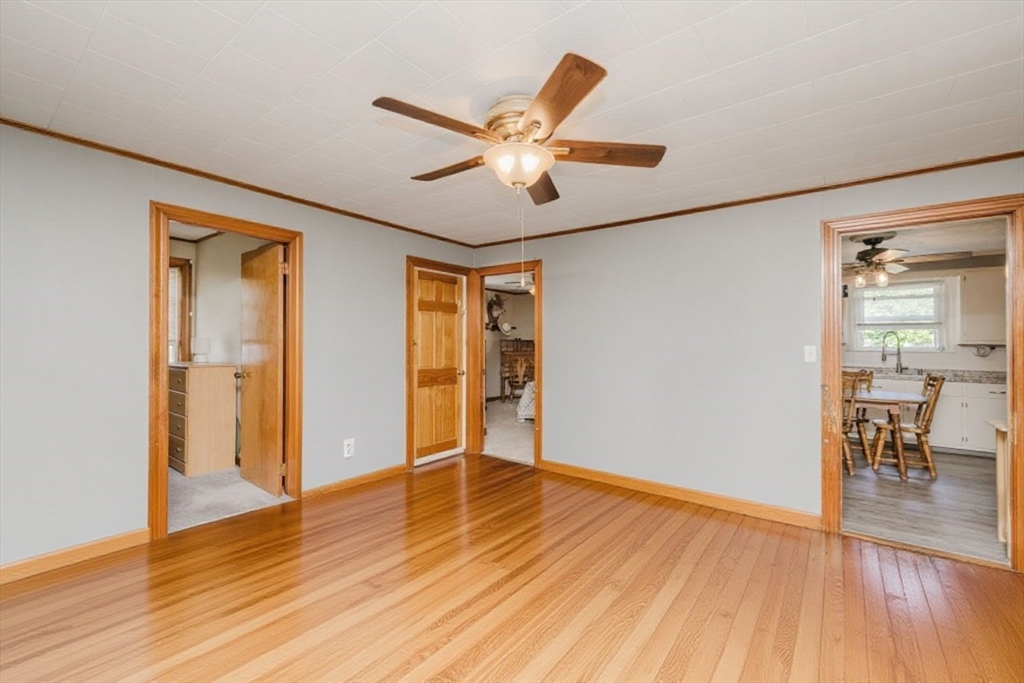 20 Wilcox Street Fall River, MA 02724 - Photo 13 of 28 a view of an empty room with wooden floor and a ceiling fan