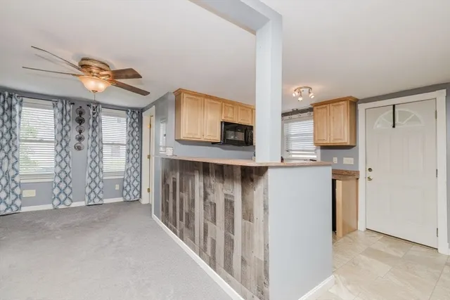 a kitchen with granite countertop white cabinets and white appliances