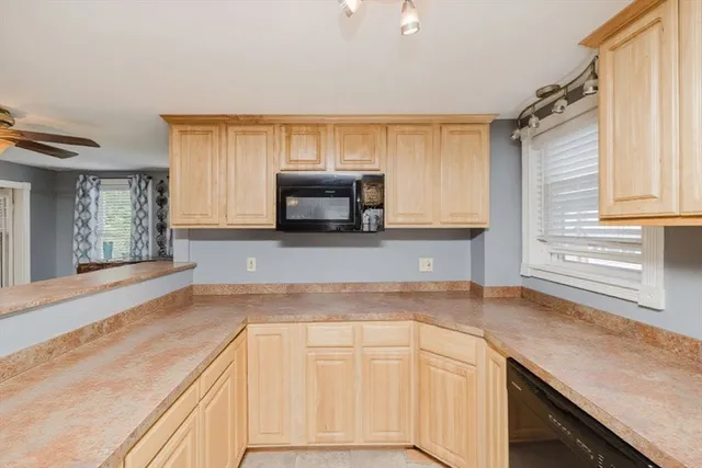 a view of a kitchen with furniture and a refrigerator