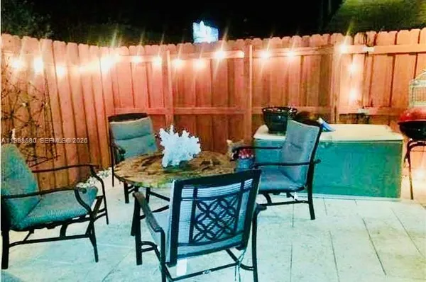a backyard of a house with table and chairs