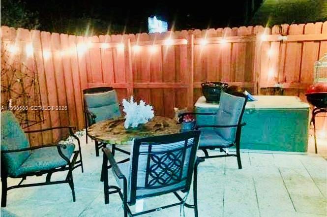 10029 Southwest 77th Court Miami, FL 33156 - Photo 5 of 10 a backyard of a house with table and chairs