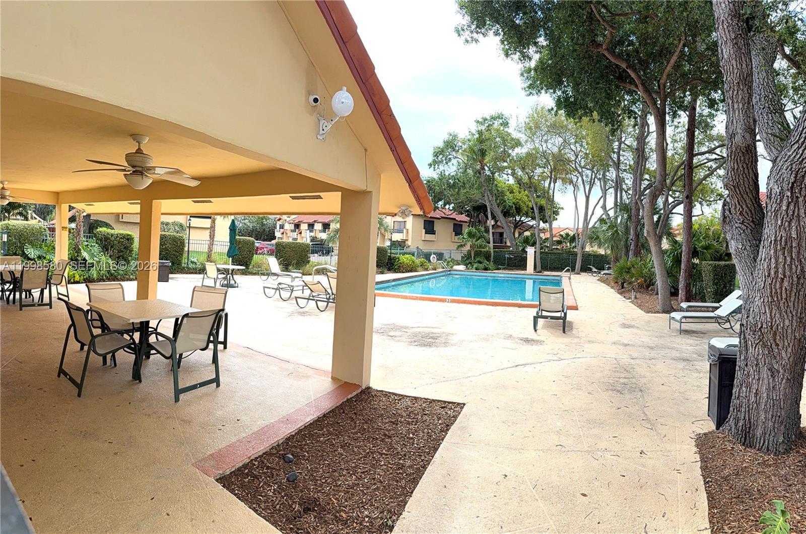 10029 Southwest 77th Court Miami, FL 33156 - Photo 9 of 10 a view of a patio with a table and chairs