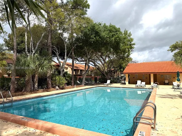 a swimming pool with outdoor seating and yard