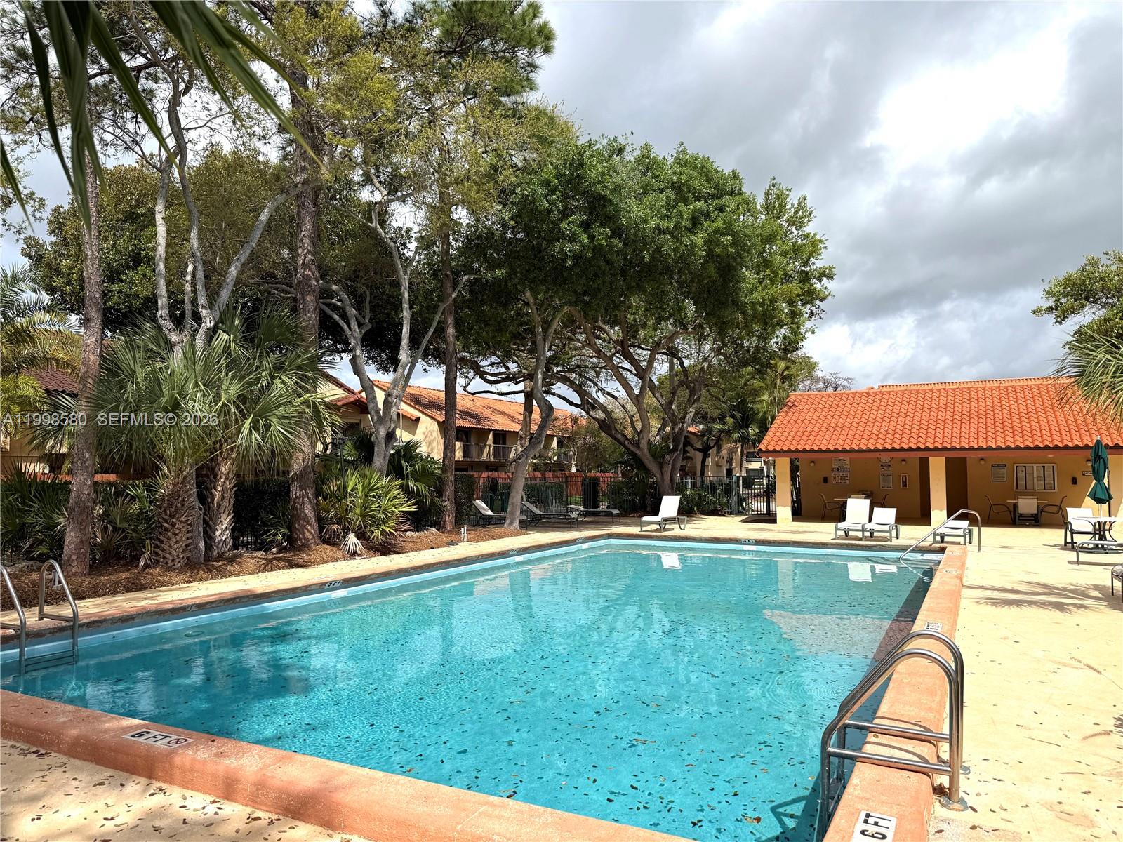 10029 Southwest 77th Court Miami, FL 33156 - Photo 10 of 10 a swimming pool with outdoor seating and yard