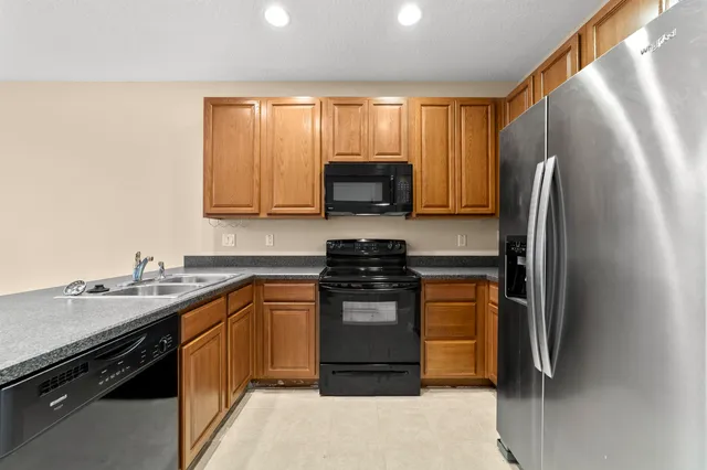a kitchen with a sink stove and refrigerator