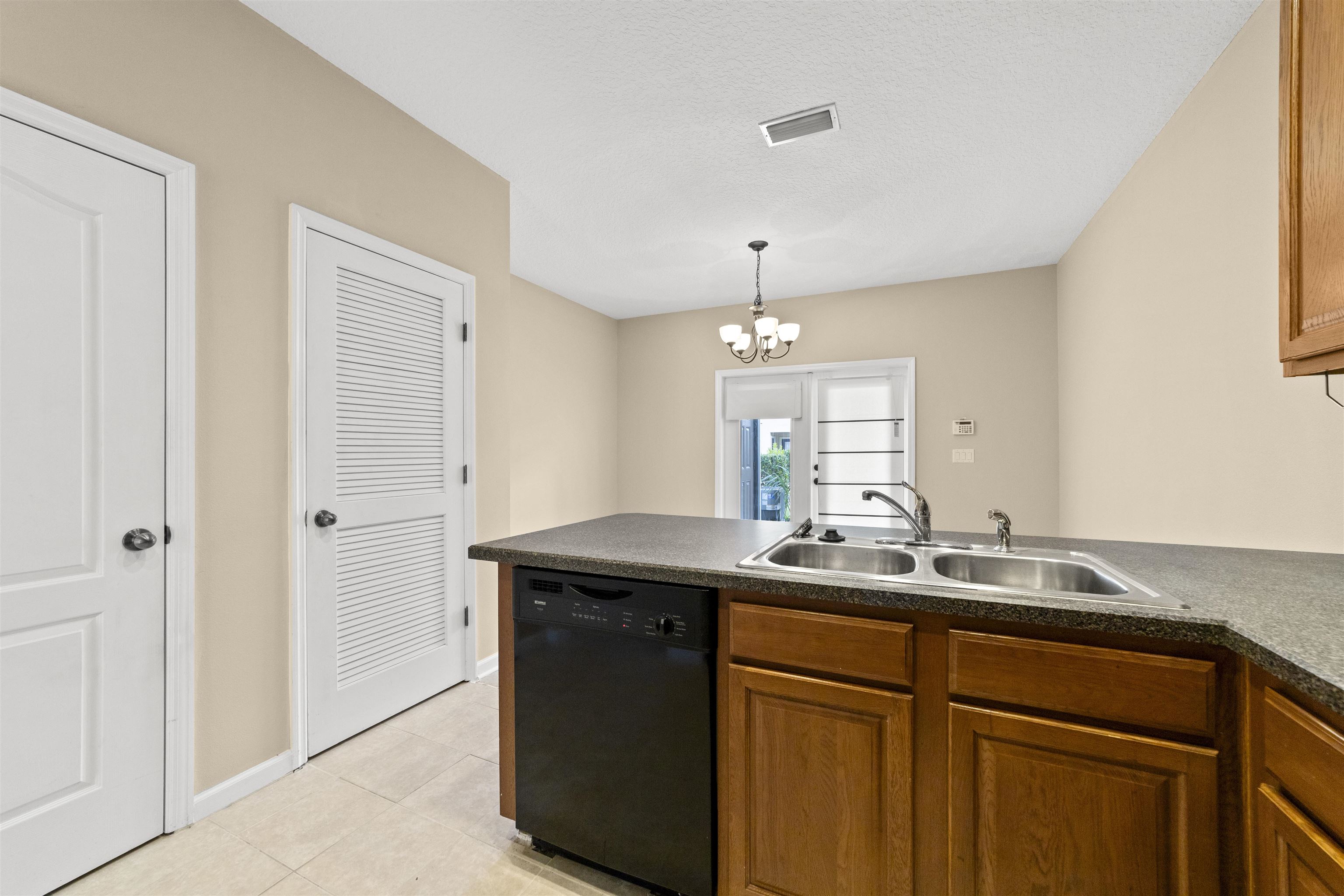 652 Drake Bay Terrace St. Augustine, FL 32084 - Photo 15 of 30 a kitchen with a sink and a refrigerator
