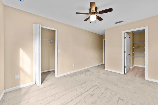 a view of empty room with ceiling fan