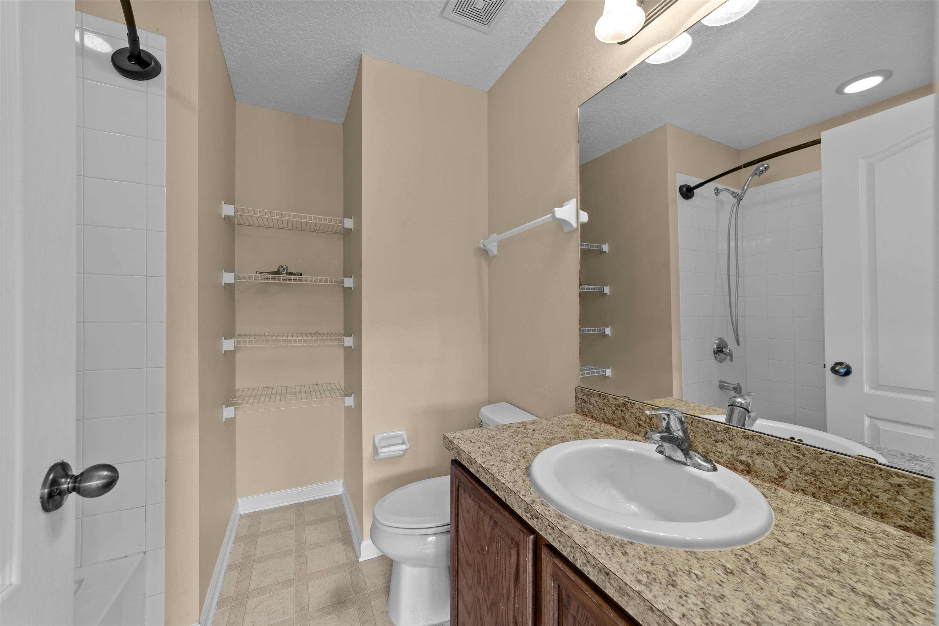 652 Drake Bay Terrace St. Augustine, FL 32084 - Photo 20 of 30 a bathroom with a granite countertop sink and a mirror