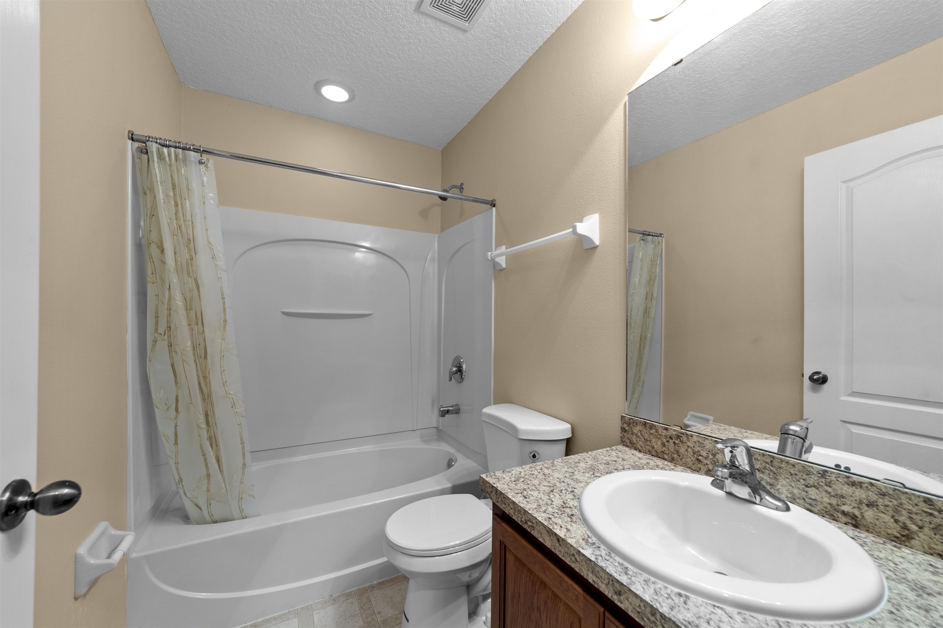 652 Drake Bay Terrace St. Augustine, FL 32084 - Photo 24 of 30 a bathroom with a granite countertop sink toilet and shower