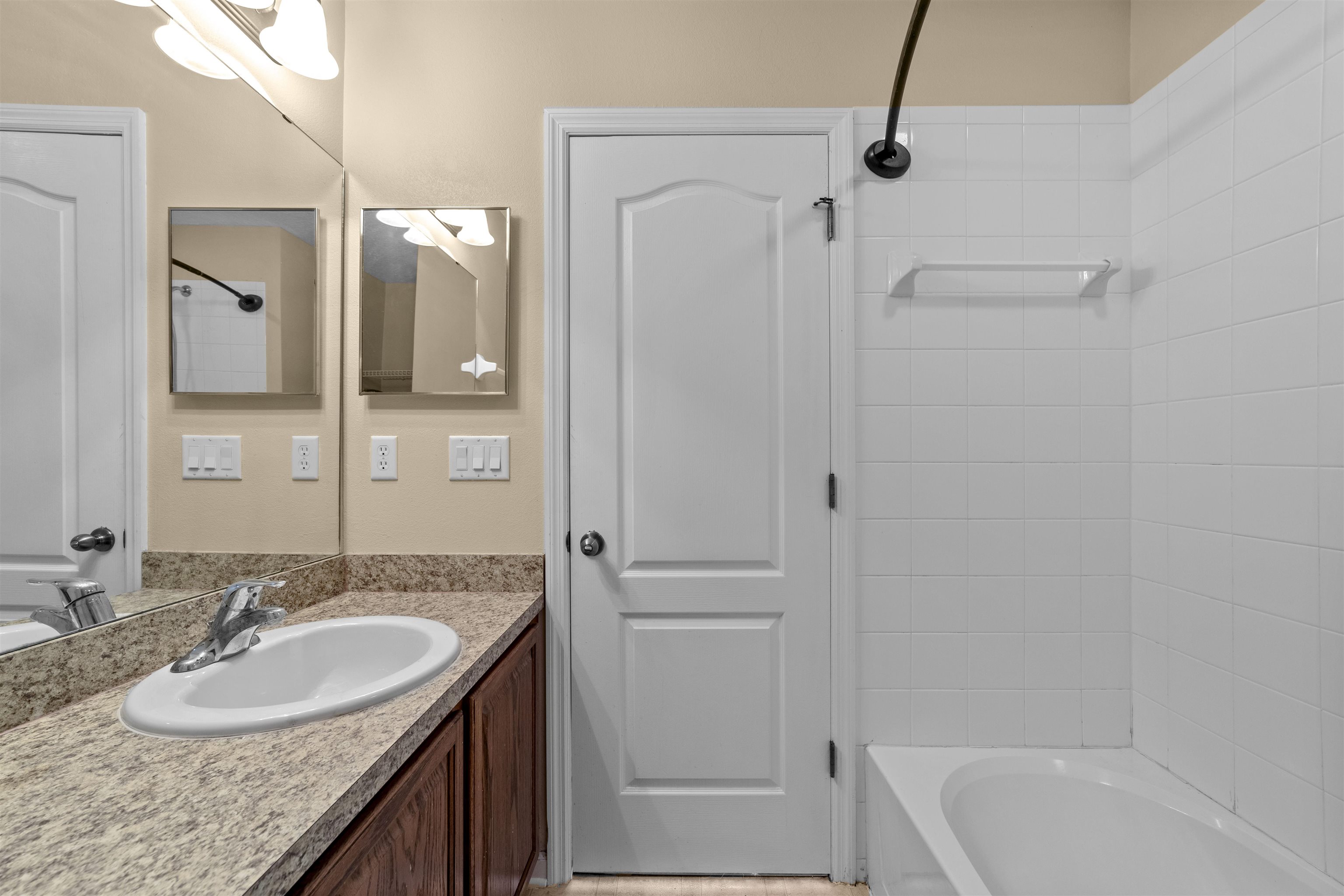 652 Drake Bay Terrace St. Augustine, FL 32084 - Photo 25 of 30 a bathroom with a granite countertop sink mirror and a bathtub