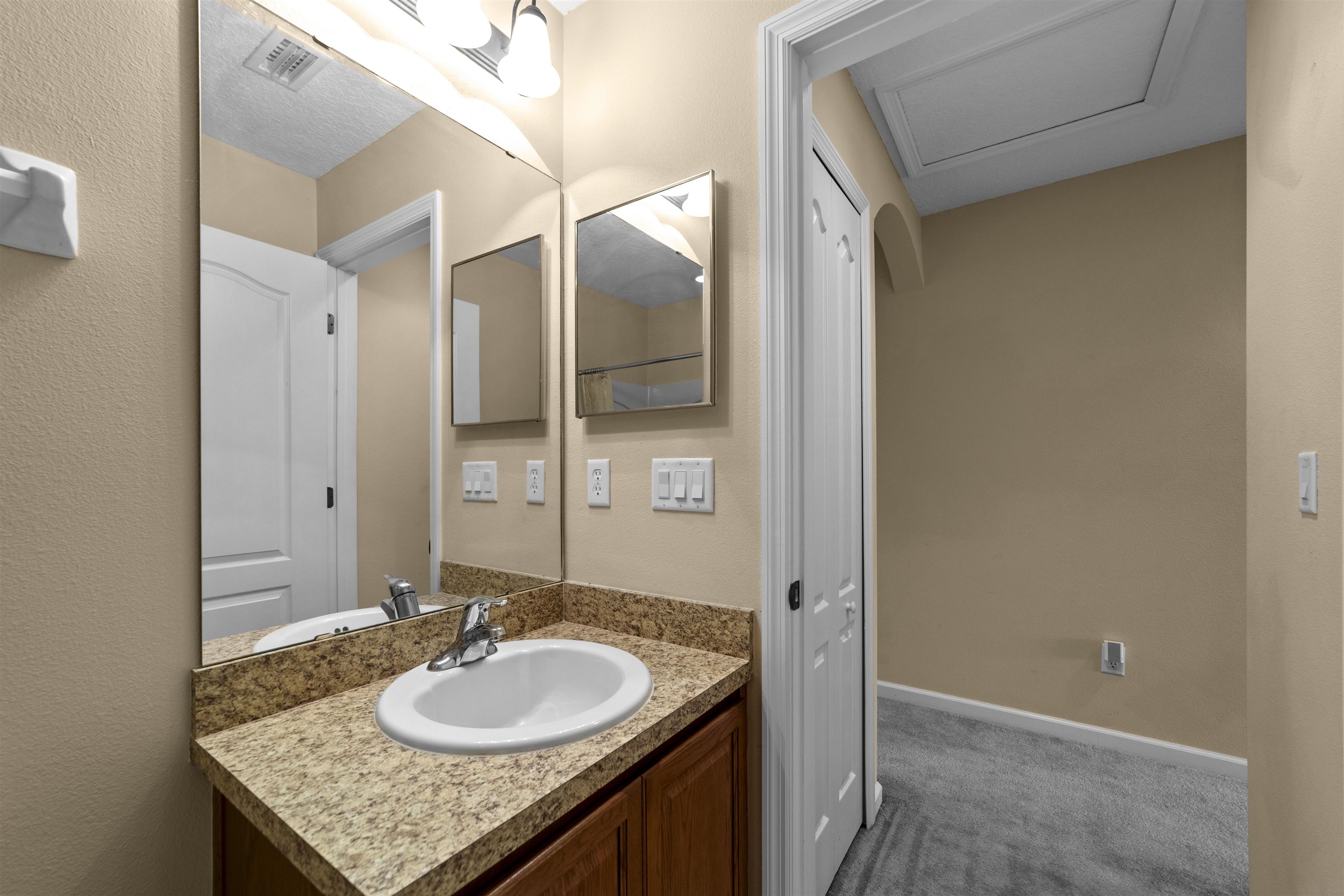 652 Drake Bay Terrace St. Augustine, FL 32084 - Photo 26 of 30 a bathroom with a granite countertop sink and a mirror