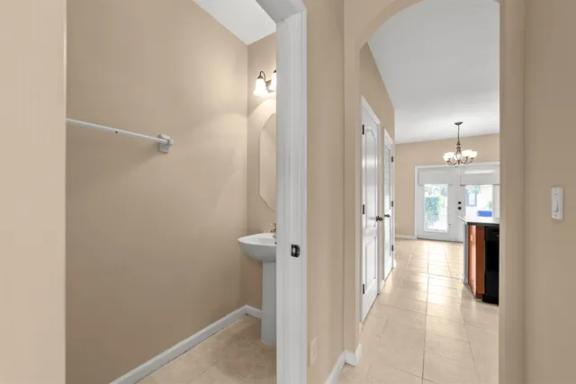 a view of a hallway with a view of bathroom