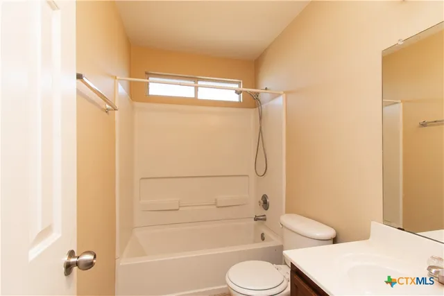 a bathroom with a toilet sink and shower