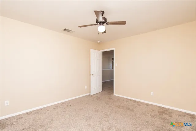 a view of a room with a ceiling fan