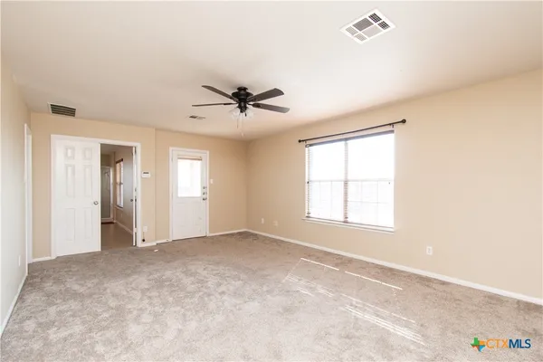 a view of an empty room with a window