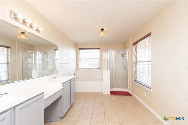 a large white kitchen with a large window