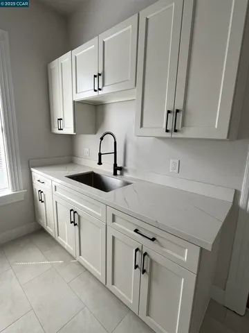 a kitchen with stainless steel appliances white cabinets and a sink