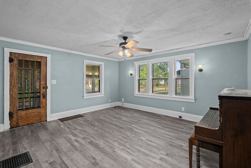 1419 17th Street Moline, IL 61265 - Photo 9 of 28 a view of an empty room with window chandelier fan and fire place