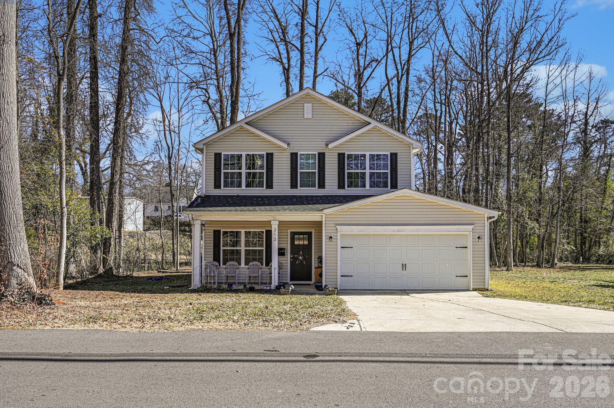 313 Bell Street Mount Holly, NC 28120 - Photo 1 of 19 a front view of a house with a garden and trees