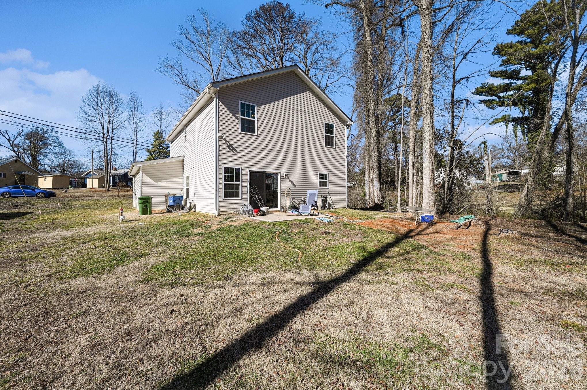 313 Bell Street Mount Holly, NC 28120 - Photo 17 of 19 a view of a white house with a yard