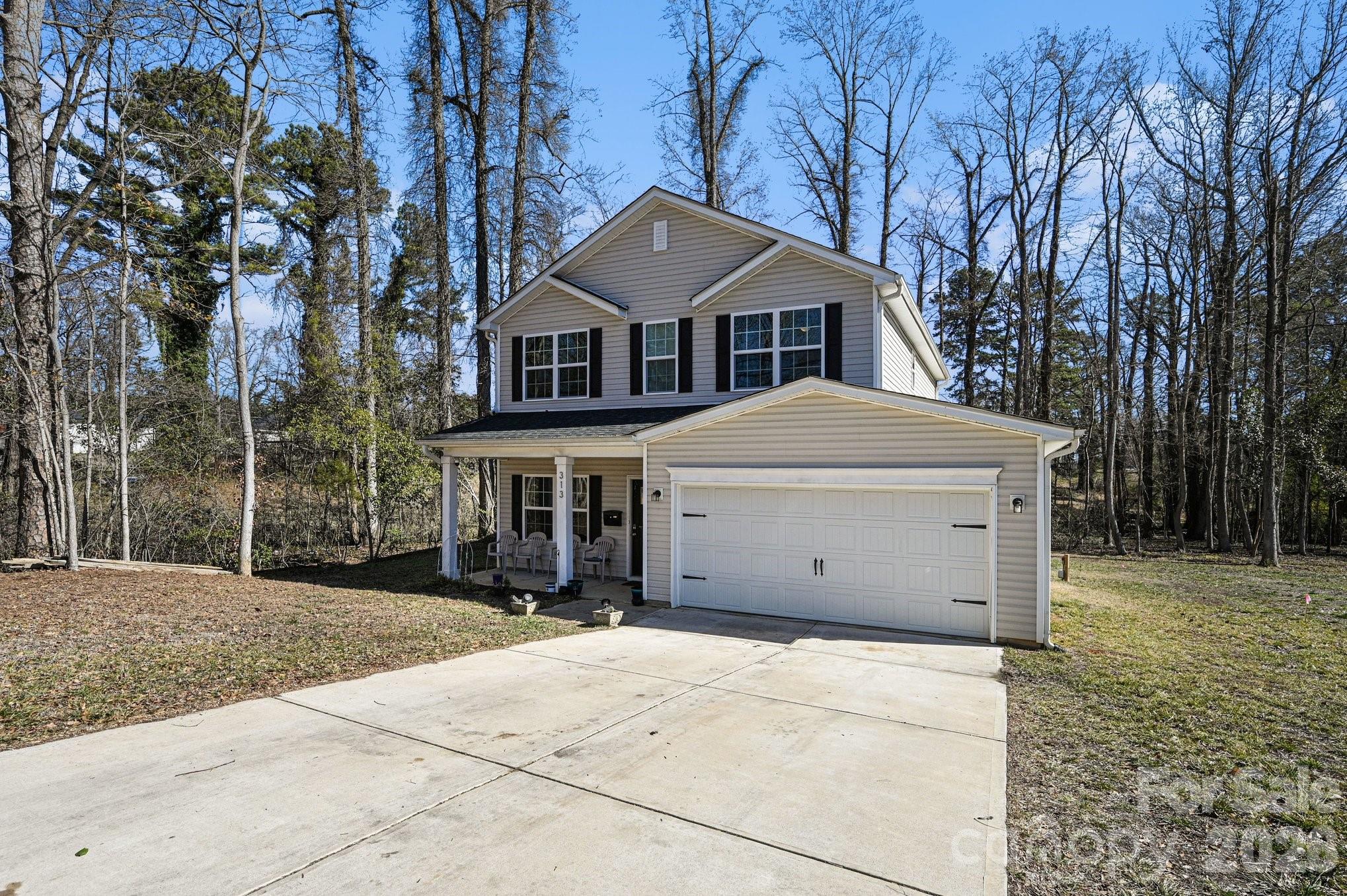 313 Bell Street Mount Holly, NC 28120 - Photo 18 of 19 a front view of a house with a yard and trees