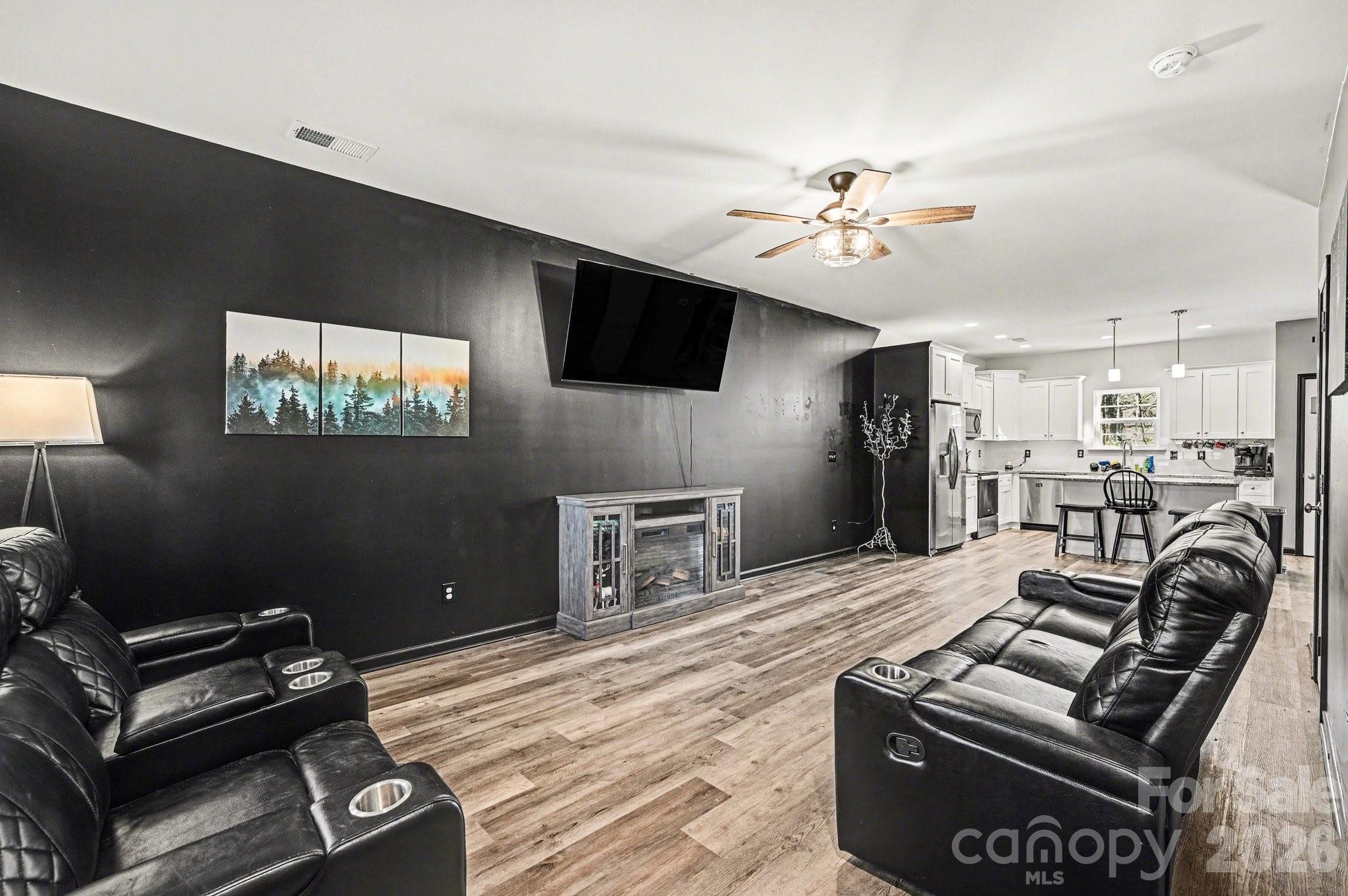 313 Bell Street Mount Holly, NC 28120 - Photo 4 of 19 a living room with furniture and a flat screen tv