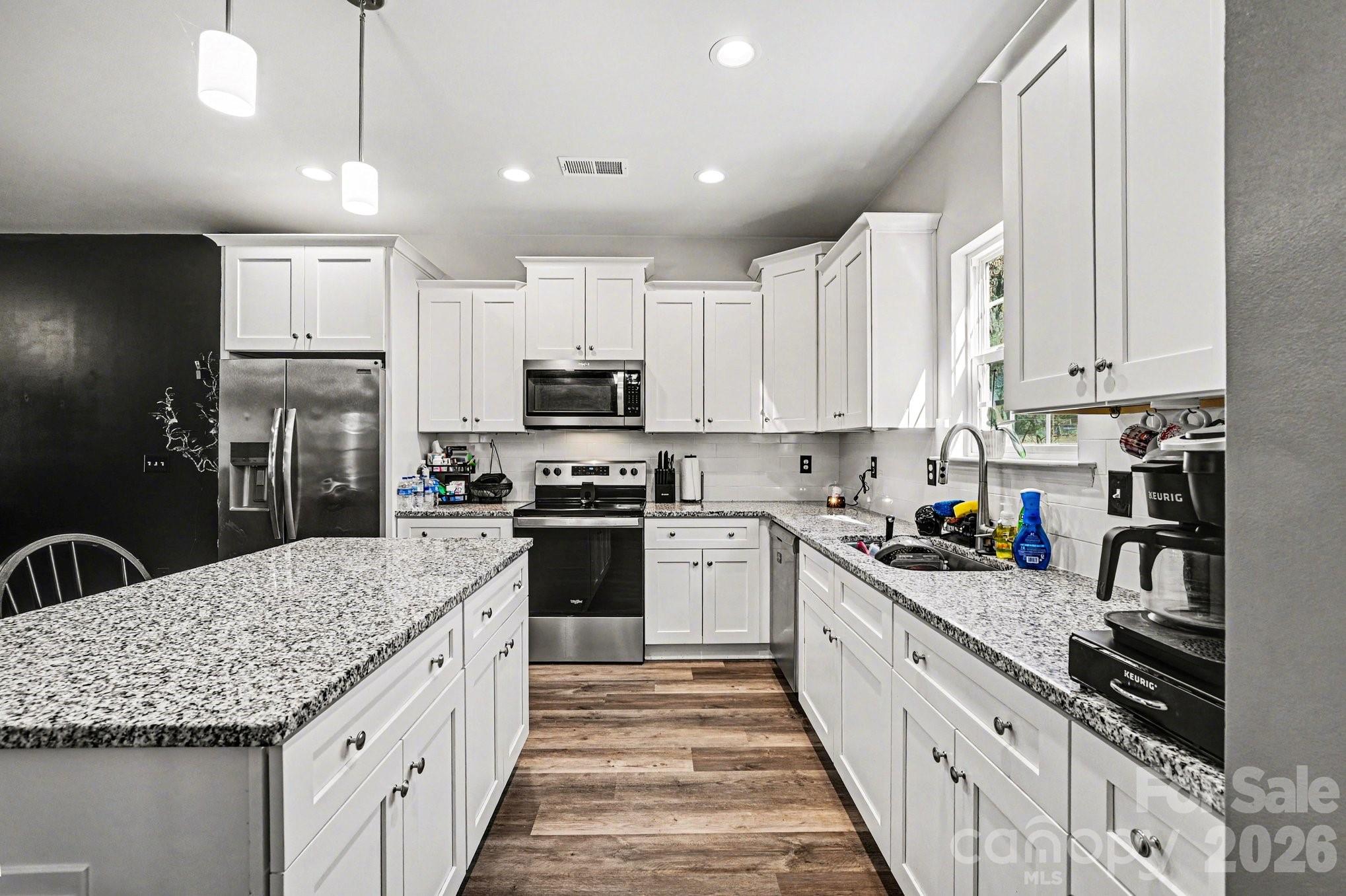 313 Bell Street Mount Holly, NC 28120 - Photo 7 of 19 a kitchen with stainless steel appliances granite countertop a sink stove and refrigerator